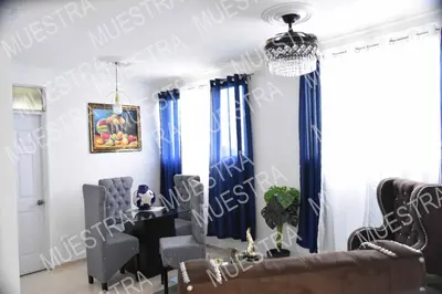 a dining room with blue curtains and a table and chairs at Apartamento en la carreras próximo al monumento in Santiago de los Caballeros