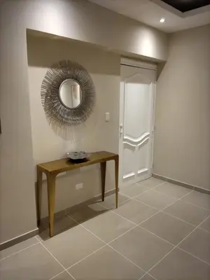 a room with a table and a mirror on the wall at Cómodo y Equipado Apt Cerca del Malecón in Santo Domingo