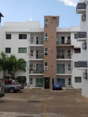 a parking lot in front of a large apartment building at Comodas 3 Habitaciones, Wifi 1er piso in Santiago de los Caballeros