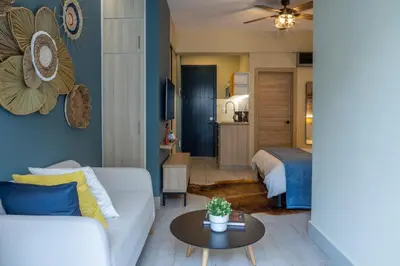 a living room with a couch and a bed at Casa Adefra Boutique Hotel Zona Colonial in Santo Domingo