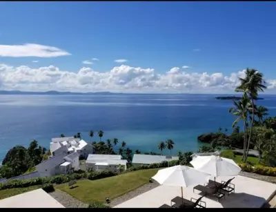 a view of the ocean from a house with umbrellas at Perfect Paradise, Oceanview in Samana in Santa Bárbara de Samaná