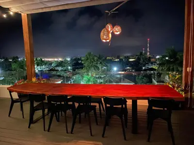 a wooden table with chairs and a red table cloth at Ultravioleta Boutique Residences in Cabarete