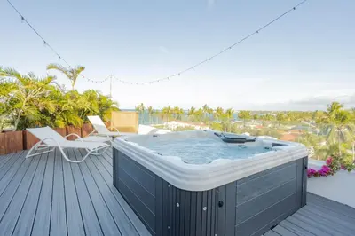 a hot tub on the deck of a house at Ultravioleta Boutique Residences in Cabarete