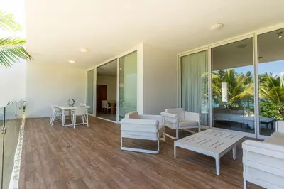 a living room with white furniture and glass windows at Ultravioleta Boutique Residences in Cabarete
