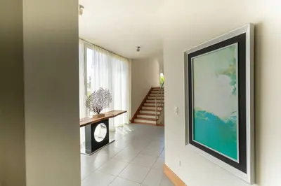 a hallway with a large painting on the wall at Ultravioleta Boutique Residences in Cabarete