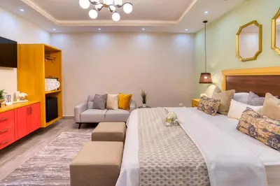 a large bedroom with a large bed and a couch at Melina Hotel in Higuey