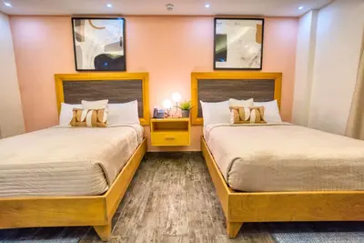 two beds in a room with two beds sidx sidx sidx at Melina Hotel in Higuey
