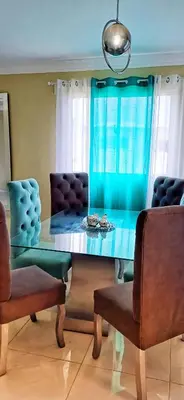 a dining room with a table and two chairs at Casa familiar in San Pedro de Macorís