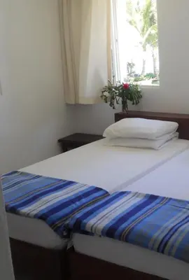 a bed in a room with a window at La Punta Apartamentos in Cabarete