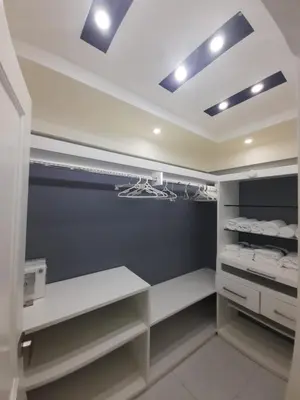 a walk in closet with white and blue walls at Hermoso apartamento Residencial madera I in Santiago de los Caballeros