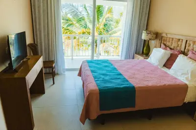 a bedroom with a bed and a television and a window at Private Villa LaPerla Iberosta 3BDR, Pool, Beach, WiFi in Punta Cana