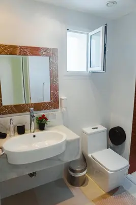 a bathroom with a sink and a toilet and a mirror at Private Villa LaPerla Iberosta 3BDR, Pool, Beach, WiFi in Punta Cana