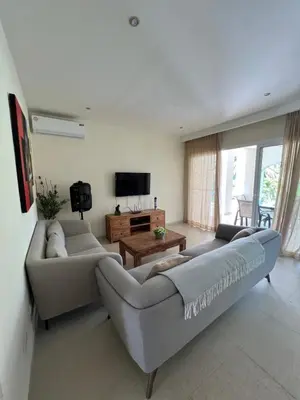 a living room with two couches and a tv at Private Villa LaPerla Iberosta 3BDR, Pool, Beach, WiFi in Punta Cana