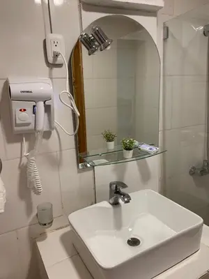 a bathroom with a white sink and a mirror at Noé Hotel ,1 Bedroom # 5 near to the beach in Punta Cana
