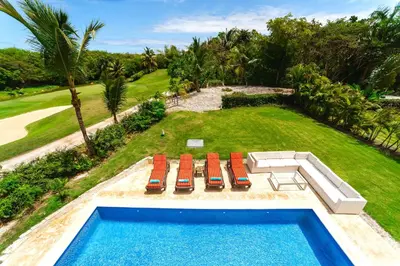an aerial view of a swimming pool with chairs and a yard at Private Iberosta Villa Fortuna - 4BDR, Pool & Private Beach in Punta Cana