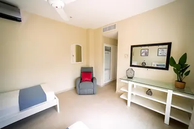 a bedroom with a bed and a desk and a chair at Private Iberosta Villa Fortuna - 4BDR, Pool & Private Beach in Punta Cana