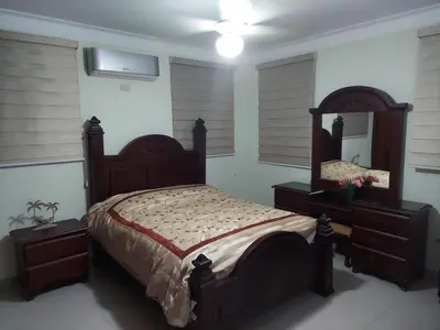 a bedroom with a large bed and a mirror at Hermosa casa urbanización Jardines del Norte in Santiago de los Caballeros