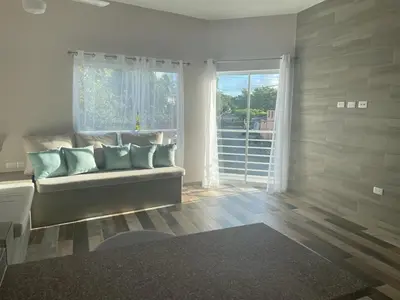 a living room with a couch and a window at Apartamentos La Torre in Río San Juan