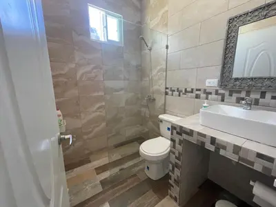 a bathroom with a toilet and a sink at Apartamentos La Torre in Río San Juan