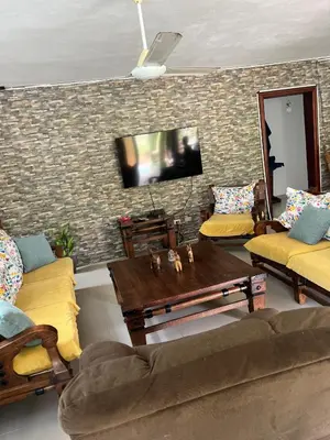 a living room with a couch and a table at Villa La Esperanza in Nizao