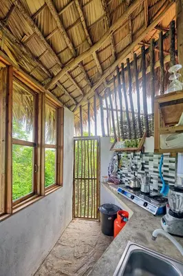 a kitchen with a sink and some windows at Tropical Cottage En Eco Casa Algana in El Limón