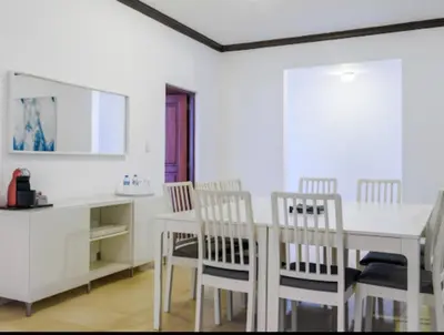 a dining room with a white table and chairs at Escape 3BR Apartment in the Heart of Piantini Nightlife in Santo Domingo