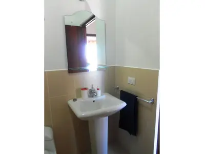 a bathroom with a sink and a mirror at Maggy's House in La Romana