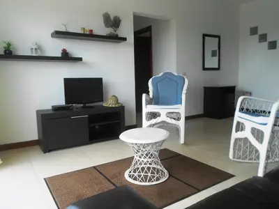 a living room with two chairs and a tv at Maggy's House in La Romana