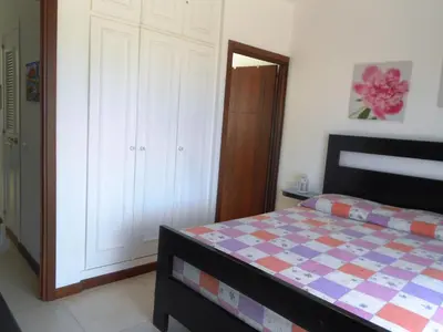 a bedroom with a bed and a closet at Maggy's House in La Romana