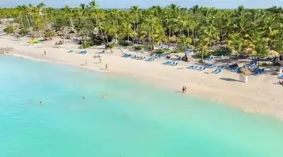 an aerial view of a beach with people and umbrellas at Glamour Hotel in La Romana