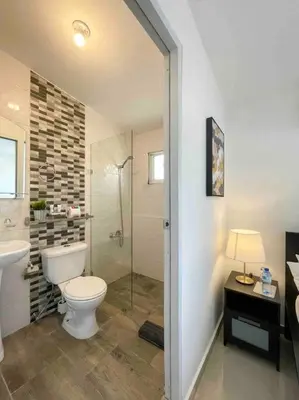 a bathroom with a toilet and a shower and a sink at Studio in Los Jardines Sleeps 2 in Santo Domingo