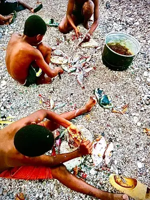 two young men sitting on the beach eating food at Local vacation beach house in Santa Cruz de Barahona