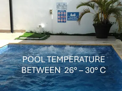 a swimming pool with a sign that reads pool temperature between at Townhouse with Private Pool and nearby beaches in Punta Cana