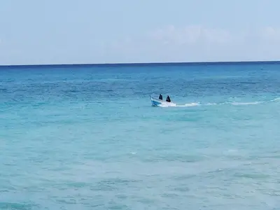 two people in a boat in the ocean at Beachfront Apartment, Quiet 4 Beds, 1 Bath, AC, Wi-Fi, Hot Water, in Paraiso near Los Patos in Paraíso