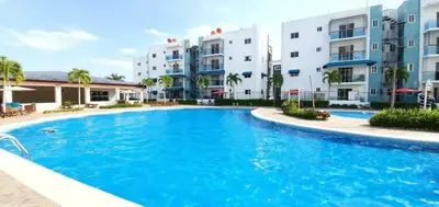 a swimming pool in front of some apartment buildings at Caribean Dreams Apartement Beautiful Pool and Gym in Santiago de los Caballeros