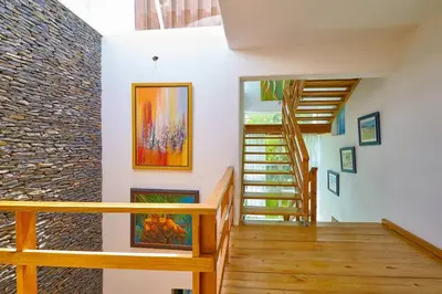 a staircase in a room with a stone wall at Escape Beach Villa in El Portillo, Las Terrenas in Las Terrenas