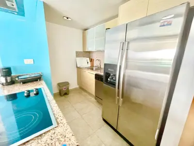 a kitchen with a stainless steel refrigerator at Marbella 2bedroom Beachfront Apartment in San Pedro de Macorís