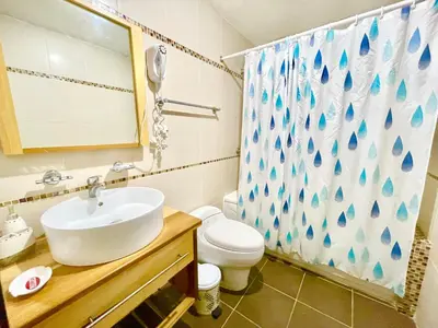 a bathroom with a sink and a toilet and a shower at Marbella 2bedroom Beachfront Apartment in San Pedro de Macorís
