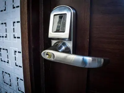 a cell phone sticking out of a wooden door at Malecon Cozy - Premium Plus 1 in Santo Domingo