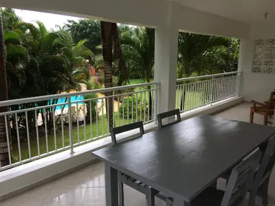 a table and chairs on a balcony with a view at Caoba in Las Terrenas