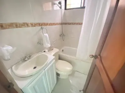 a bathroom with a sink and a toilet and a tub at 9DR 3-Bedroom Apartment Near Monumental Area in Santiago de los Caballeros