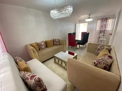 a living room with two couches and a table at 9DR 3-Bedroom Apartment Near Monumental Area in Santiago de los Caballeros