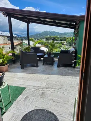 a patio with furniture and a view of the mountains at Lovely tiny studio in Jarabacoa