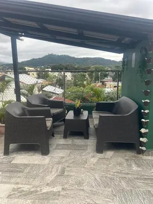 a patio with couches and a table with a view at Lovely tiny studio in Jarabacoa
