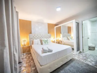 a bedroom with a large white bed in a room at Stylish 1r-1b Apt Near The Beach And Main Street in Sosúa