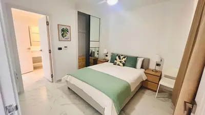 a bedroom with a large bed and a mirror at Luxury Apartment With Pool And Golf View in Punta Cana
