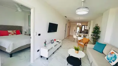 a living room with a bed and a couch at Luxury Apartment With Pool And Golf View in Punta Cana