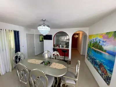 a dining room with a table and chairs at Santiago Center Huge Apartment 2stay rooftop to enjoy the city view 6-3 in Santiago de los Caballeros