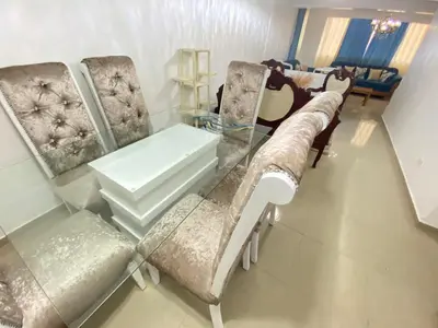 a living room with a glass table and chairs at 8 Santiago Monumental Area Cozy and lovely to enjoy 3 bedrooms Apart transportation 24 hours in Santiago de los Caballeros