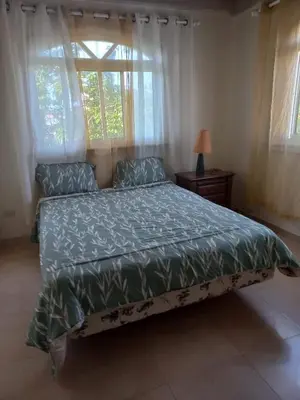 a bedroom with a bed and a window at casa maria in La Romana